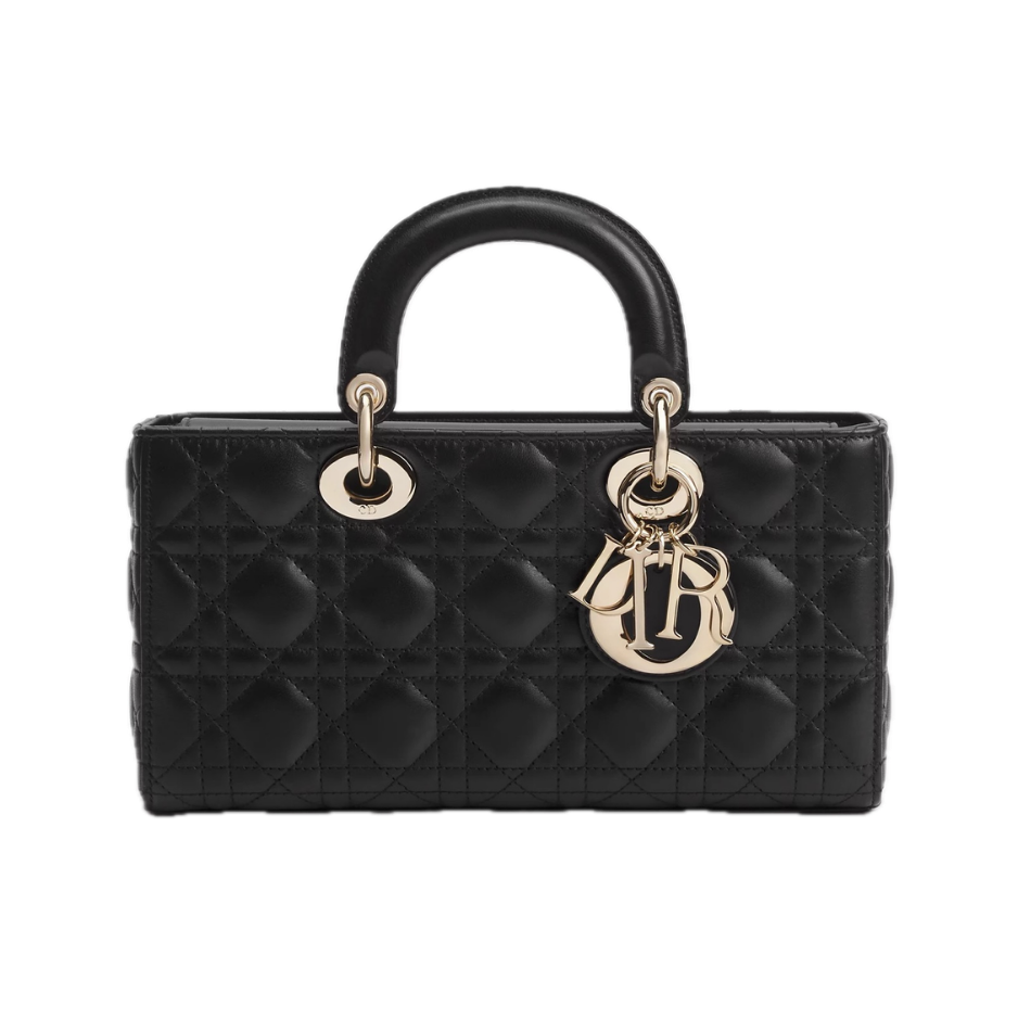 Lady Dior black quilted lambskin cannage handbag with black leather top handles, gold CD charms, and signature Dior lettering — Lady Dior bag, classic black designer handbag, luxury investment bag