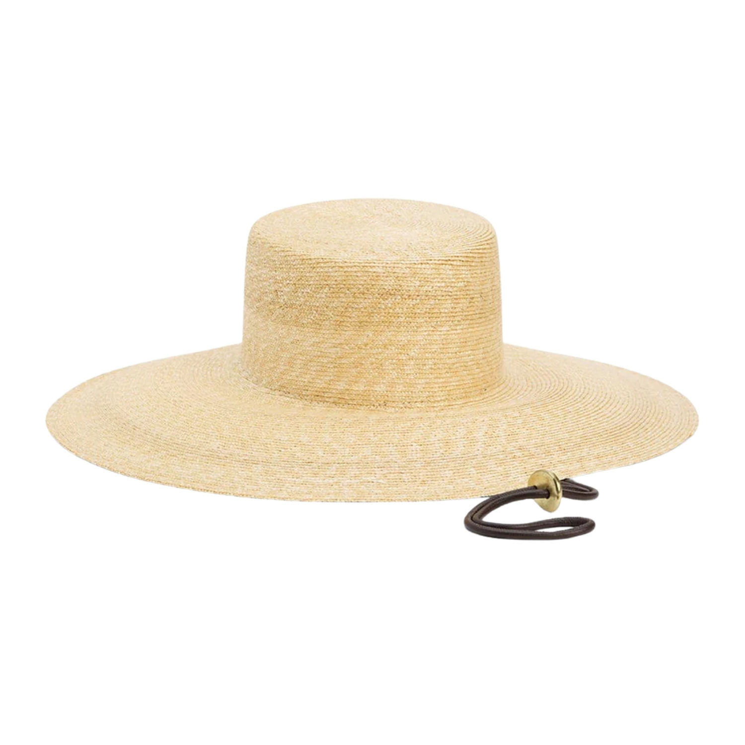 A golden natural straw boater-style hat with a flat, structured crown and an extra-wide floppy brim. A dark cord chin strap with a small brass hardware detail adds a utilitarian-chic accent.